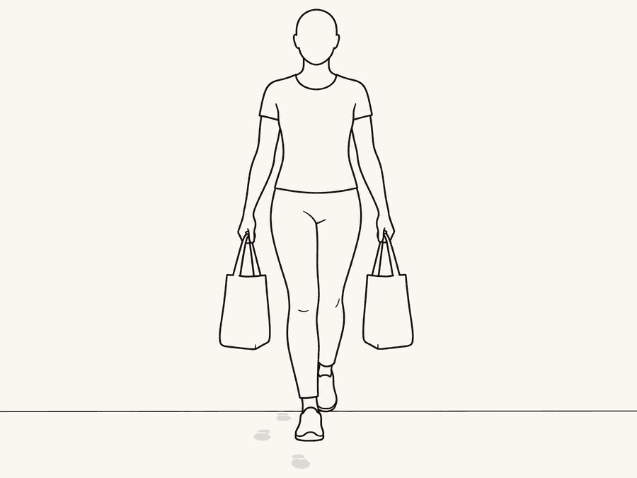 Loaded carry: walking tall holding a bag in each hand, the everyday movement trained on purpose